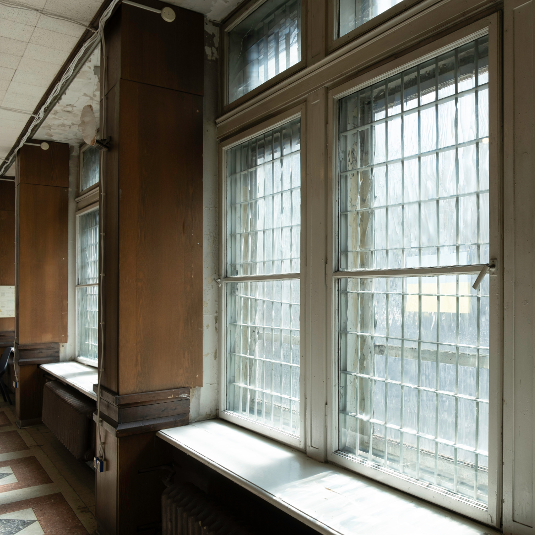 Interior of the Corner House in Riga, which used to be the KGB headquarters. The photo is focused on two windows with a third window on the left separated by a column. There is a reflection of light on the first window, but otherwise you cannot see through them.