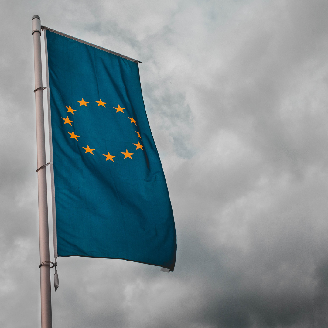 The flag of the European Union against a moody, dark sky.
