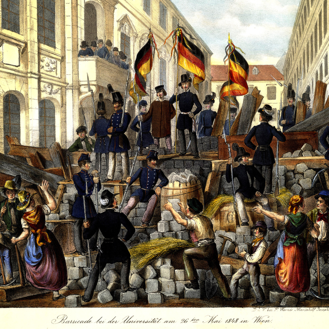 Image of the barricades of 1848 in Vienna near the university. In the middle of the picture soldiers and a man in black clothing on the barricade, some of them are holding black-red-yellow flags. In the foreground people are adding bricks to the barricade and on either side two female figures are pictured giving instructions.