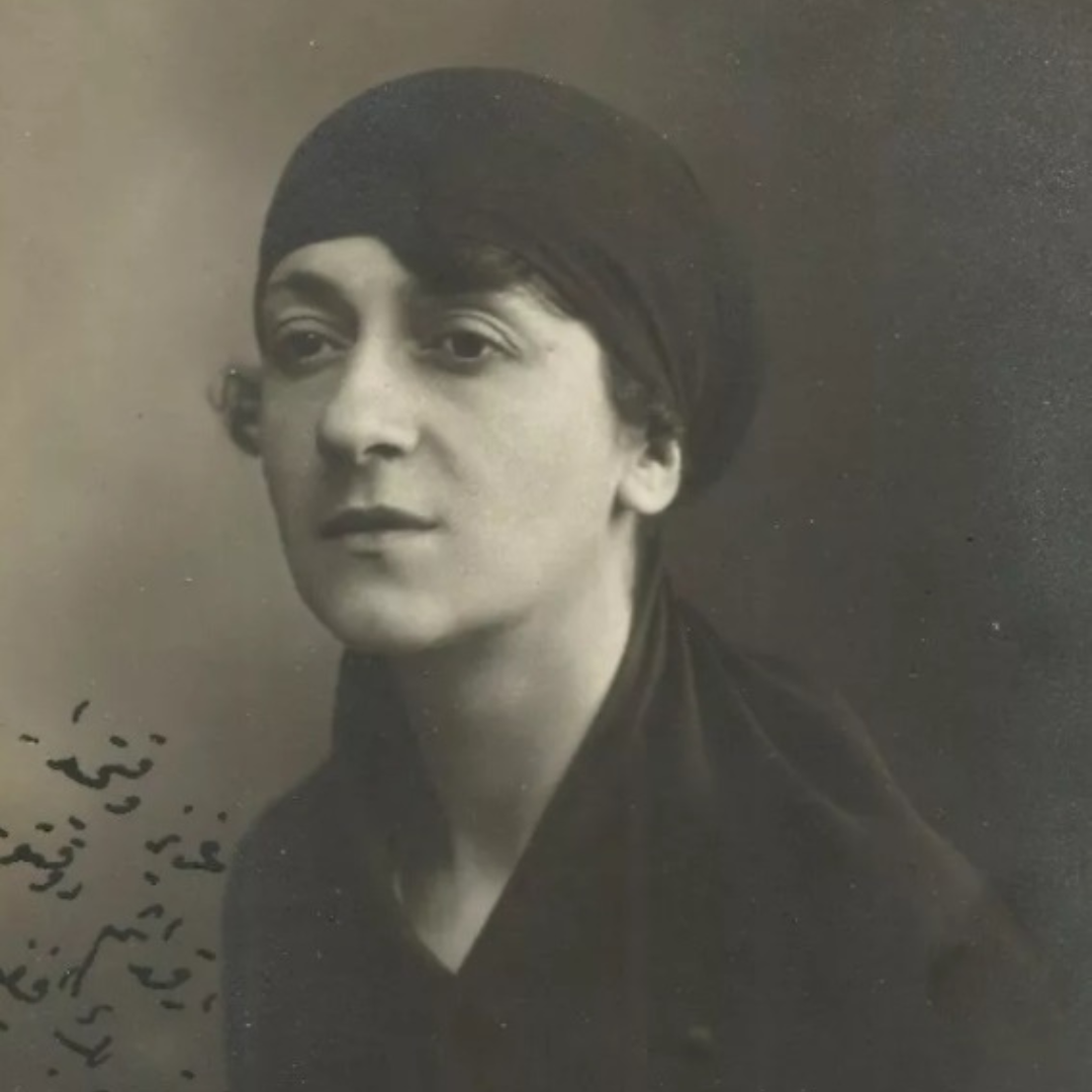 Sepia picture of Nezihe Muhiddin. In the portrait picture, she is looking into the distance. There is Arabic writing on the lower left-hand corner of the picture.