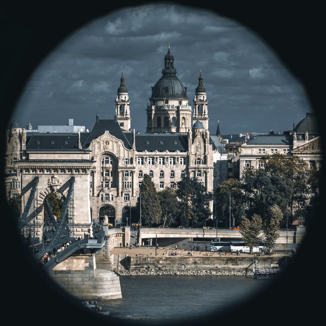 A view of St Stephen's Cathedral through in a circular view. On the bottom you can see the Danube and the Chain bridge to the left. The picture has a moody quality.