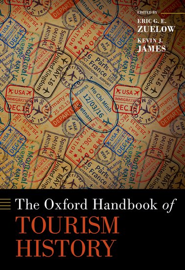 Book cover featuring a patterned collage of passport stamps, visas, and travel markings in muted tones. Overlaid at the bottom is a black band with the title The Oxford Handbook of Tourism History in large white and orange text, and the editors’ names, Eric G. E. Zuelow and Kevin J. James, in smaller white text at the top right.