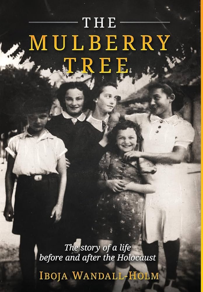 Cover of The Mulberry Tree by Iboja Wandall-Holm. A black-and-white photograph shows five children standing closely together outdoors, smiling and interacting casually, suggesting friendship or family bonds. They wear simple mid-20th-century clothing. The title appears in large yellow letters above them. At the bottom, the subtitle reads: “The story of a life before and after the Holocaust,” with the author’s name beneath.